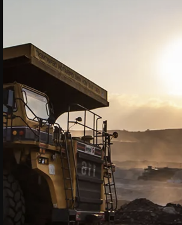 Large bulldozer on an earthworks site at sunset, representing how InSAR supports civil engineering projects by monitoring settlement and slope stability.
