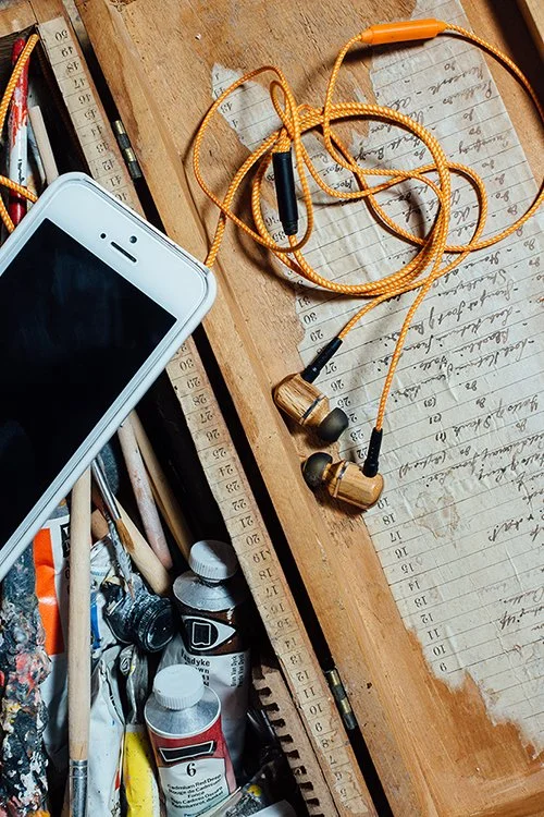Art supplies, music and notes providing design inspiration.