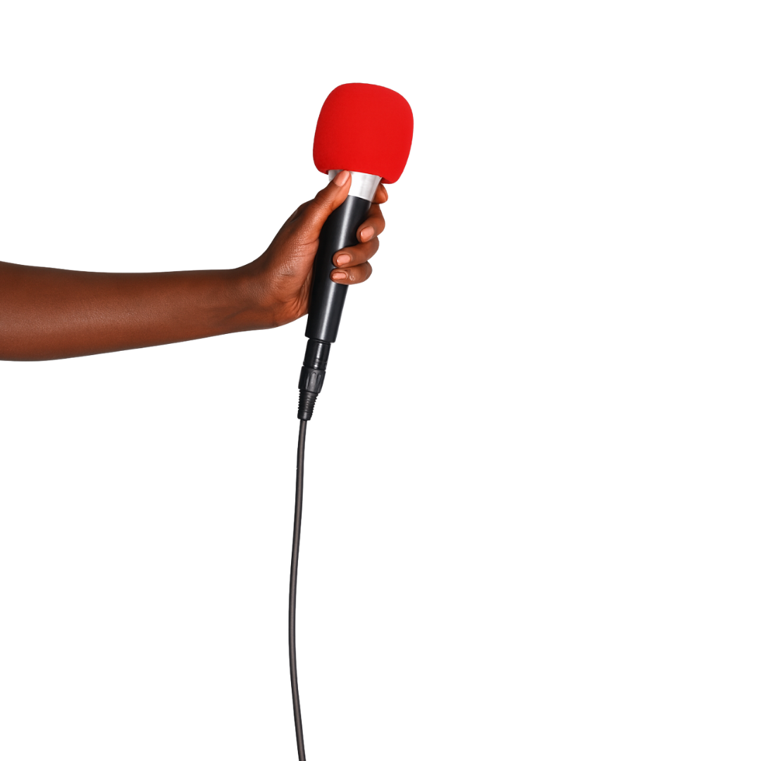 A person's hand holding a microphone with a red foam cover.