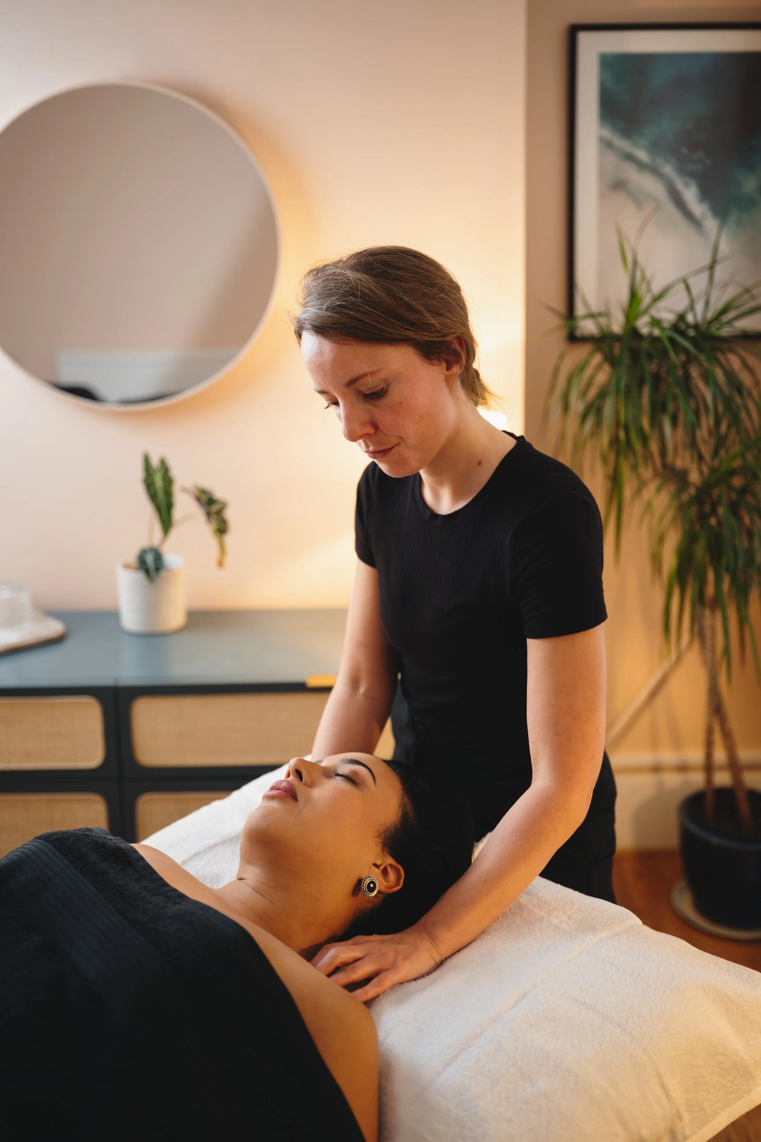 Person receiving a massage on their calf muscles from a massage therapist.
