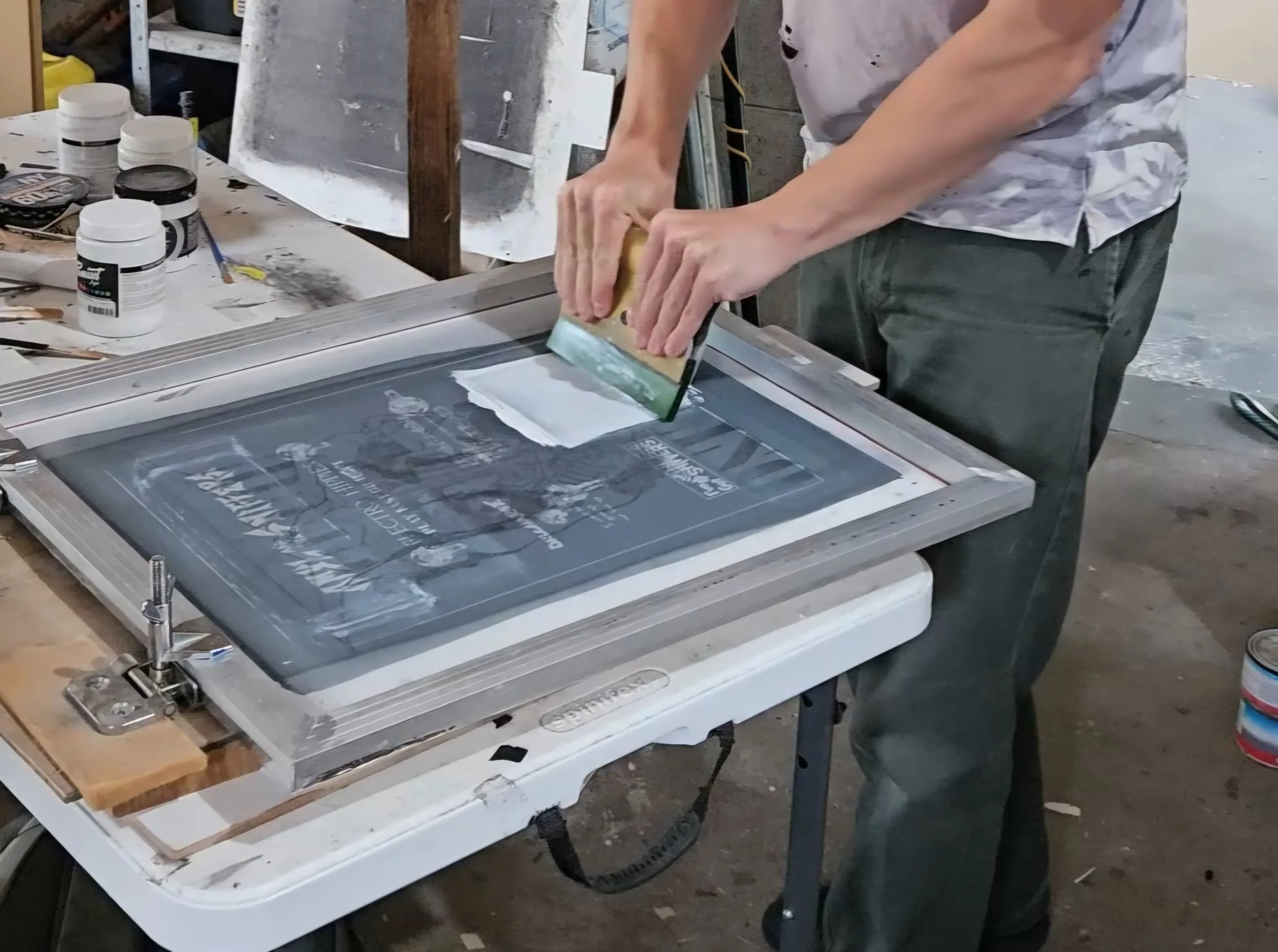 Screen printing a sew on patch with water based ink on canvas material.