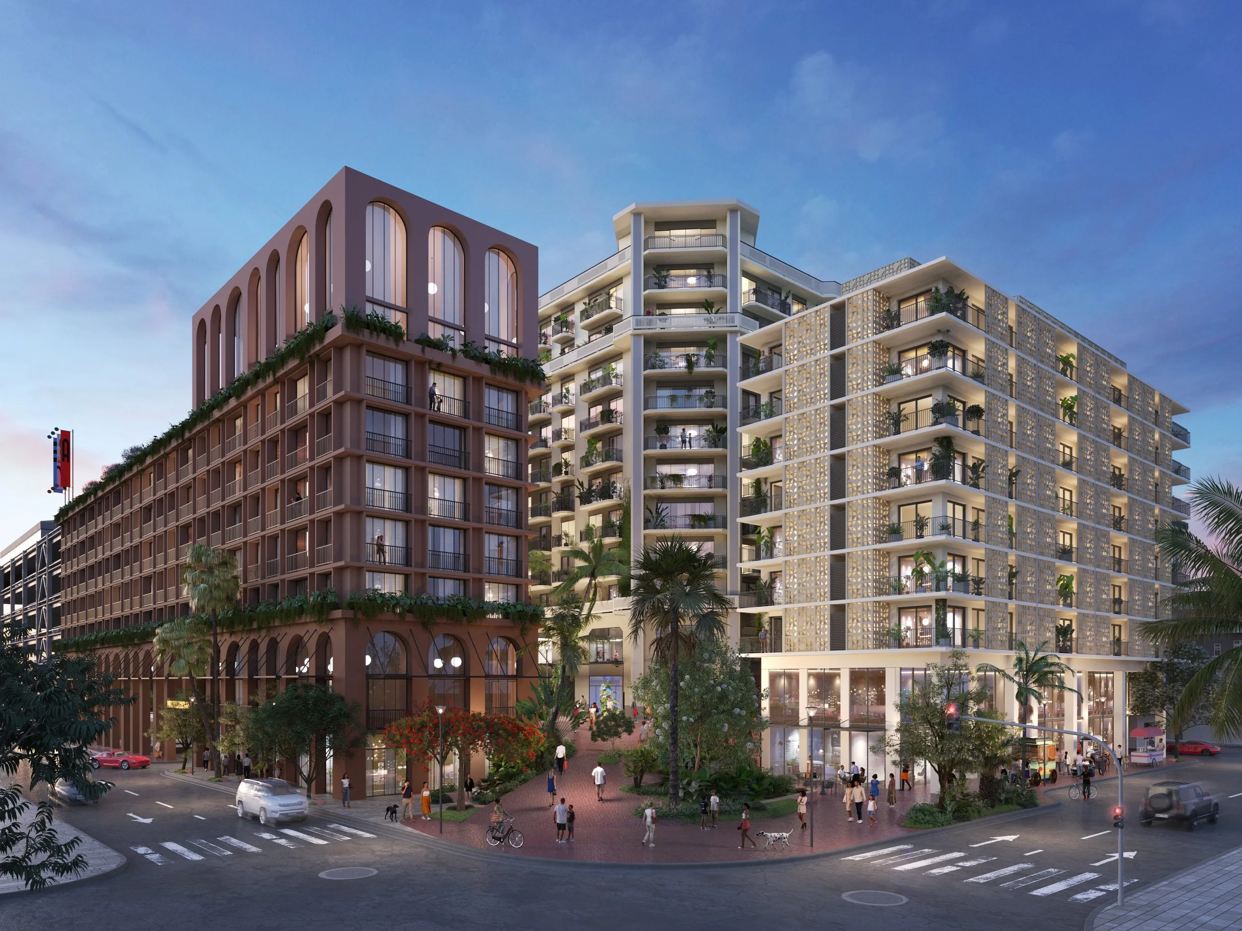 Modern mixed-use buildings with public space, trees, and people on the street at dusk.