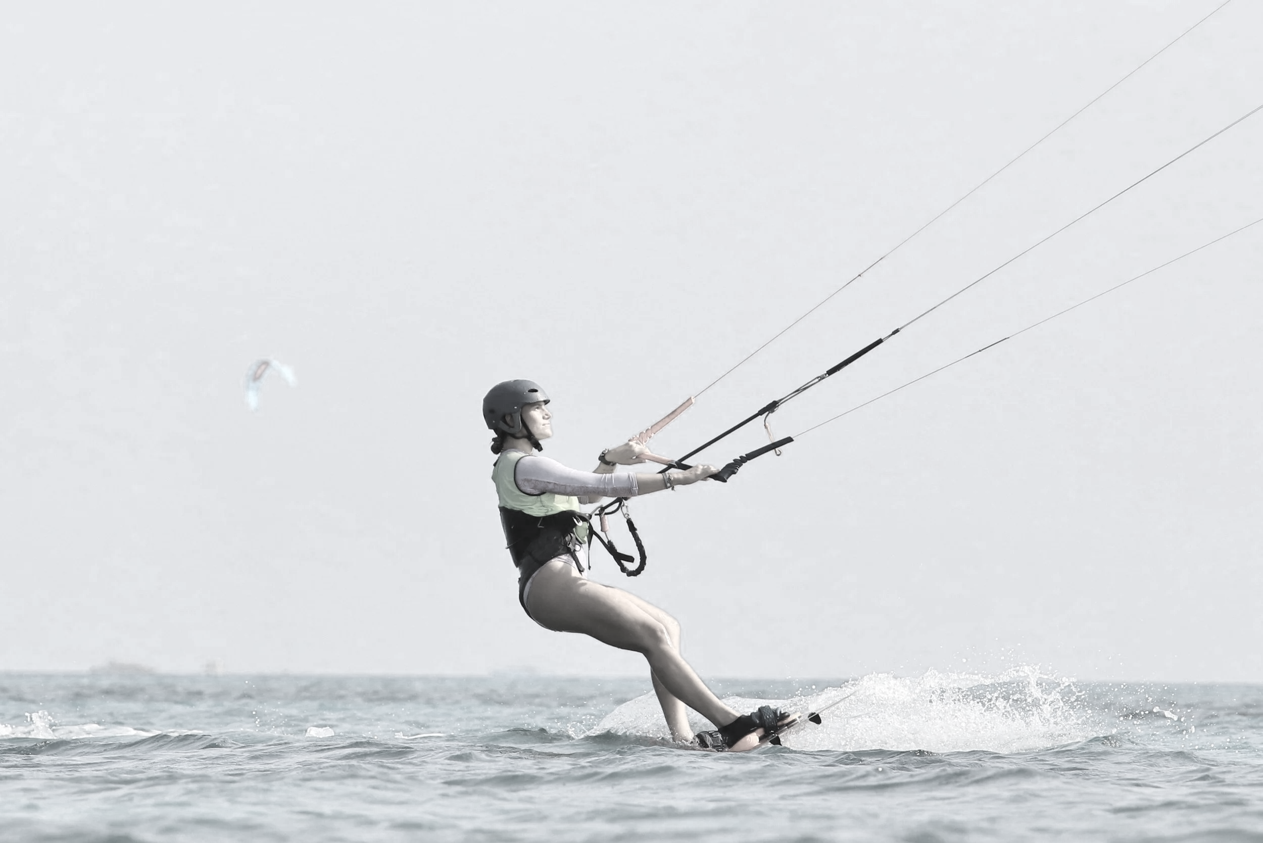 Kitesurfing moment in open water, illustrating athletic discipline, outdoor sport, and an active lifestyle.