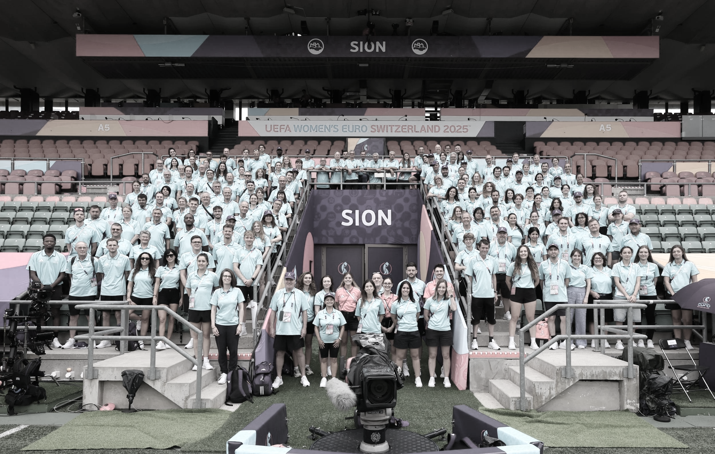 Large group of volunteers and coordinators at the UEFA Women’s EURO in Sion, symbolising successful international sport event delivery and workforce management.