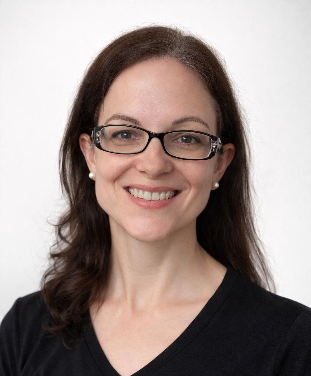 Portrait of Rachel Sagris wearing glasses and a black top against a white background.