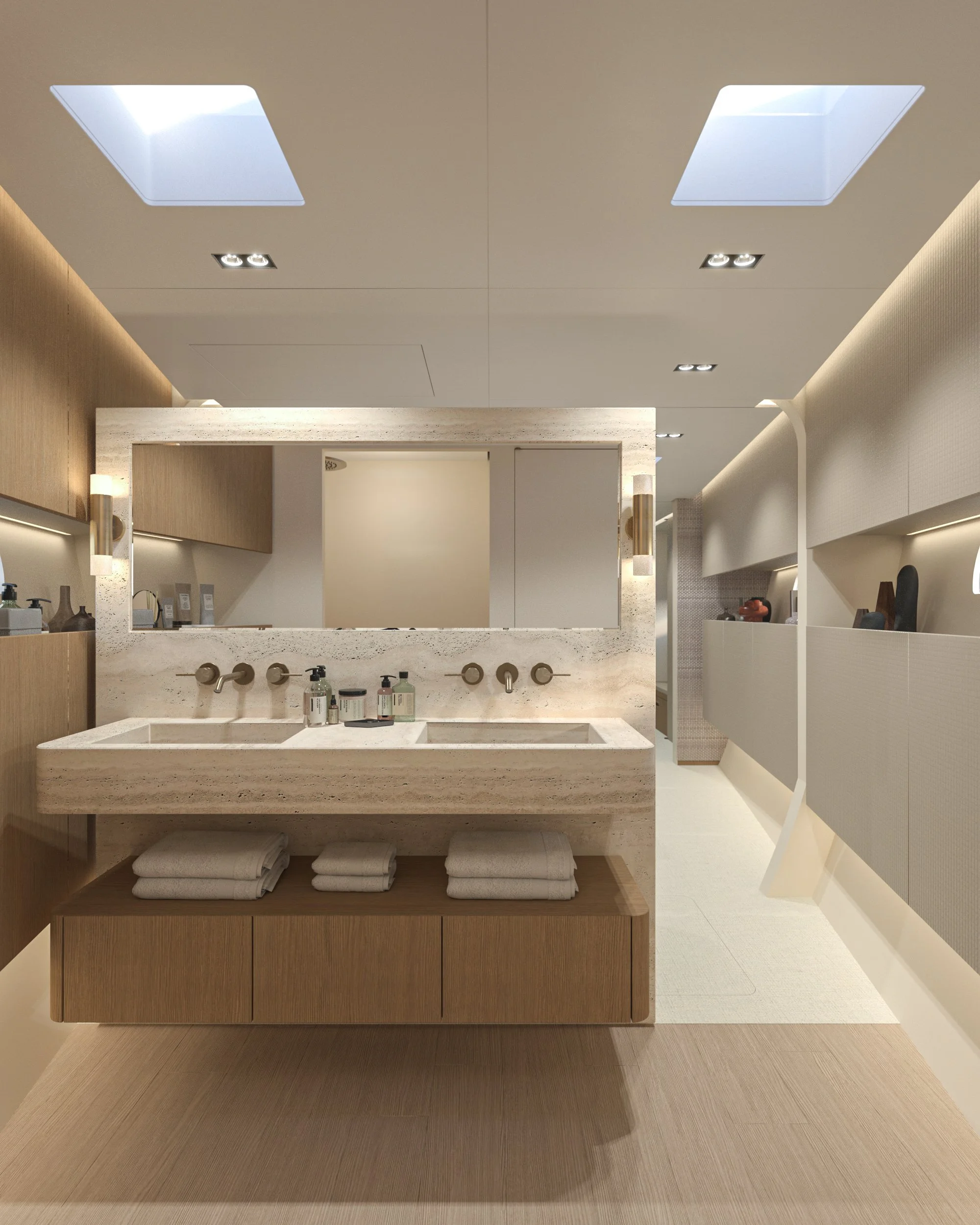 Salle de bain moderne avec double lavabo en pierre, grands miroirs, serviettes blanches pliées, et espace lumineux avec plafonnières et fenêtres de toit.