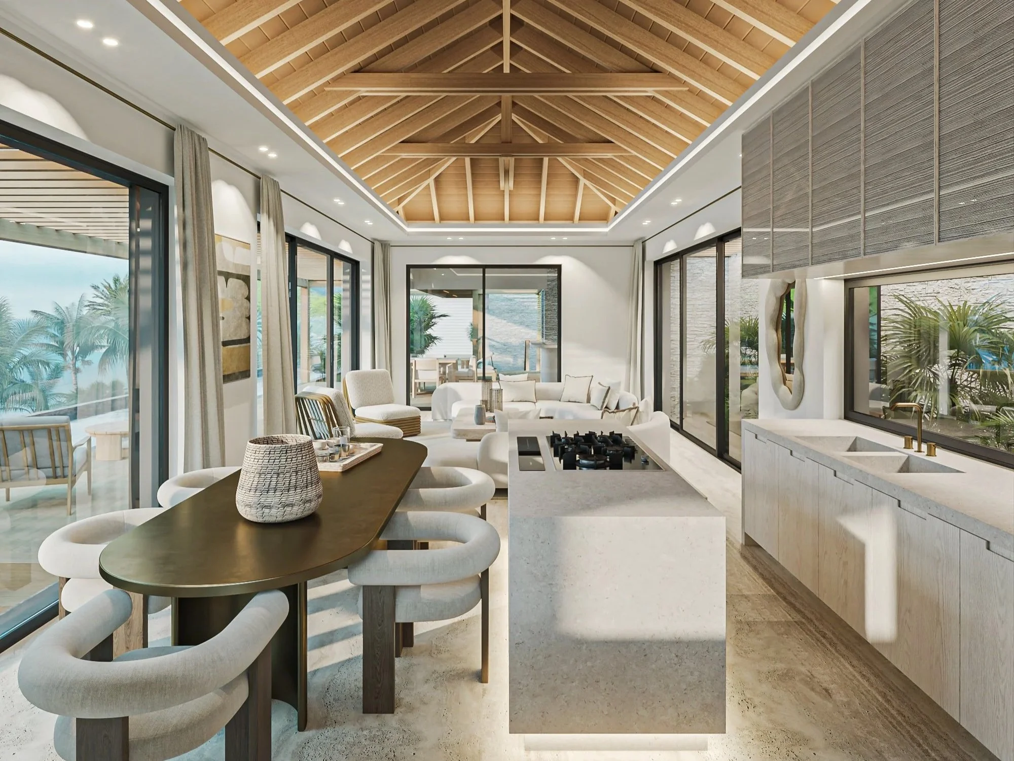 Cuisine moderne avec un plafond en bois, large fenêtre, îlot central, évier à gauche, espace salon avec canapé blanc et grande baie vitrée donnant sur une terrasse extérieure avec vue sur la mer.