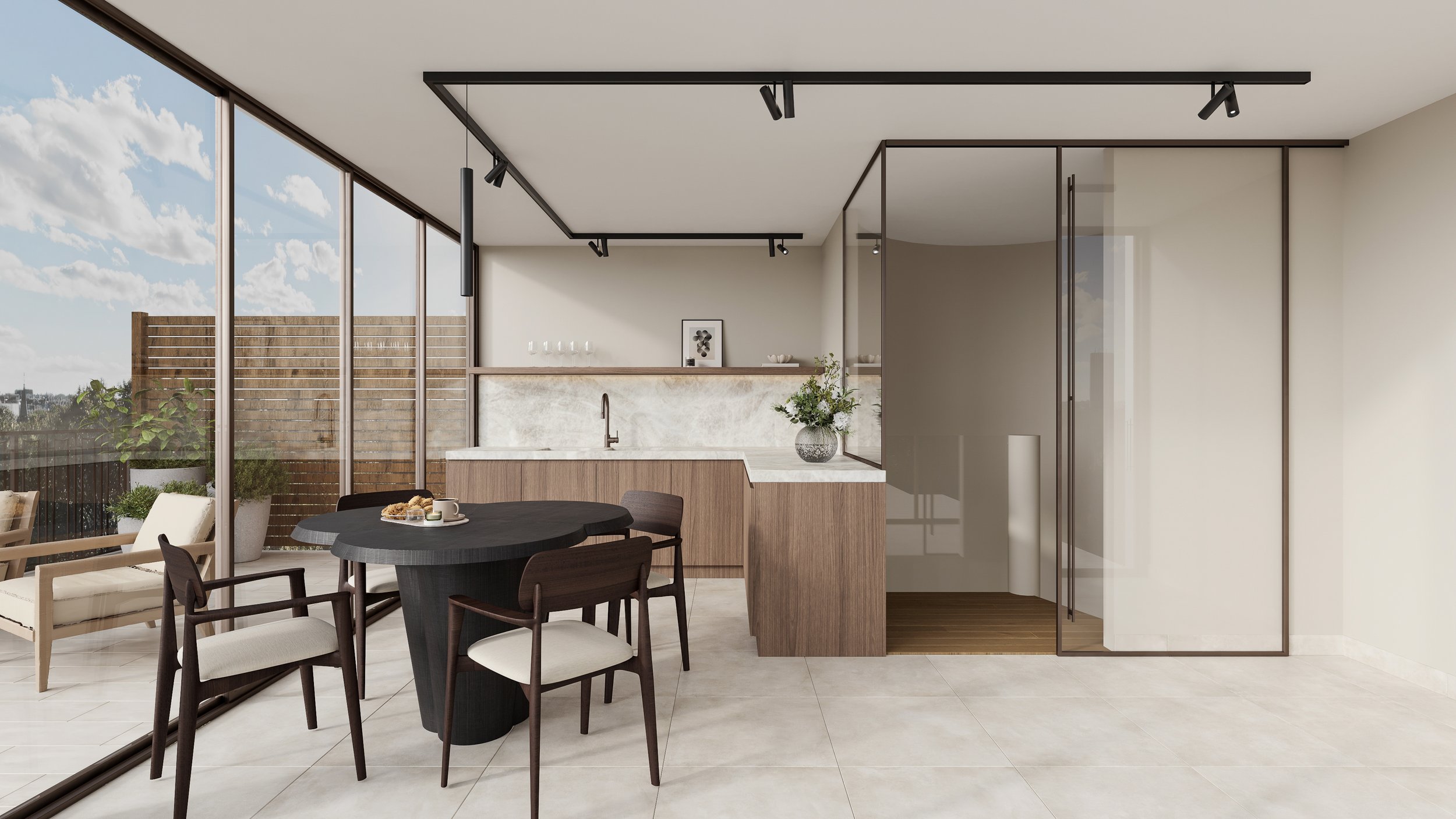 Intérieur d'une cuisine moderne avec un coin repas, tables en bois foncé, grandes fenêtres laissant entrer la lumière naturelle, et un espace délimité par des murs en verre.