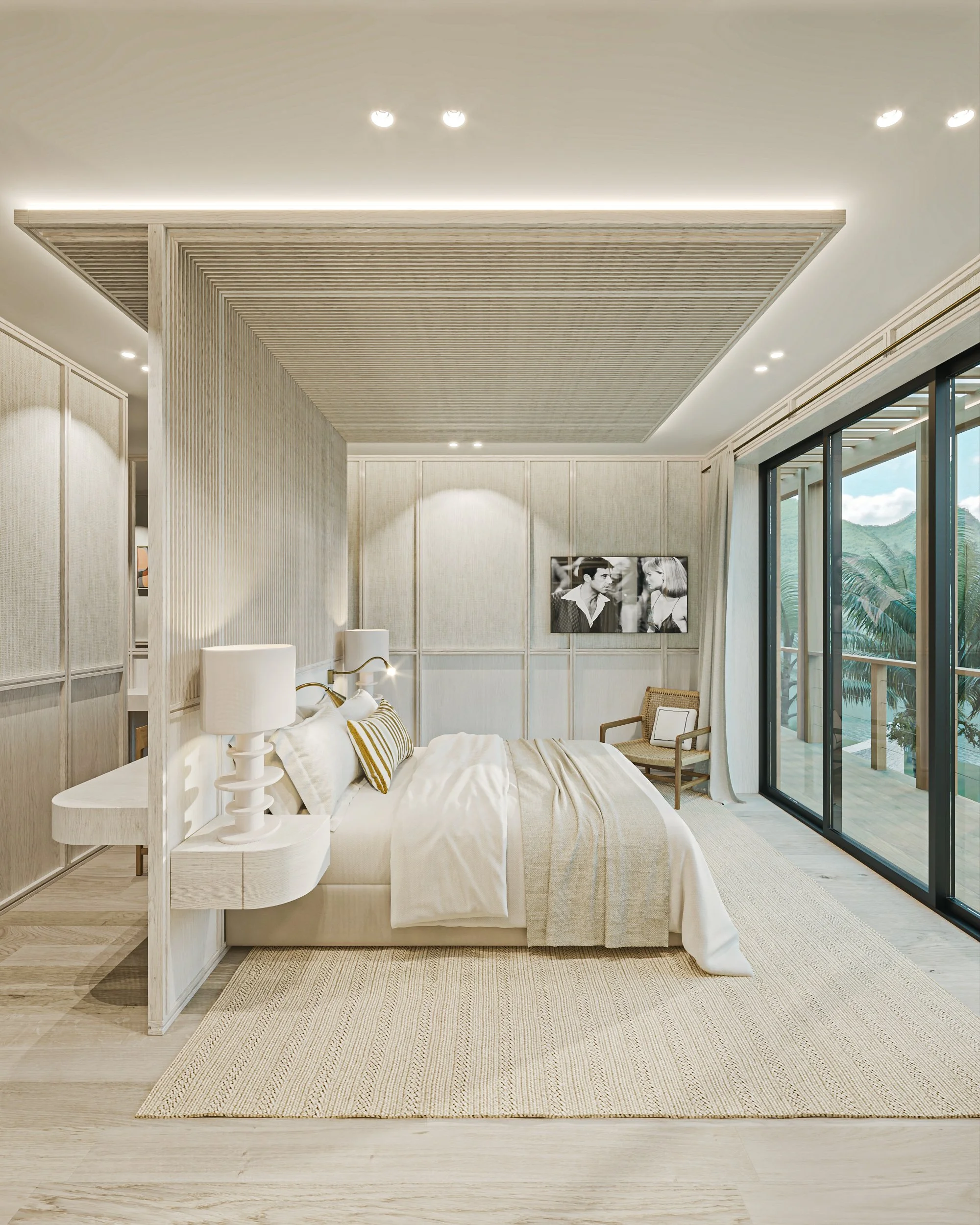 Chambre de style moderne avec lit blanc, lampes de chevet, tableau noir et blanc, fauteuil en bois, grandes fenêtres avec vue sur la nature.