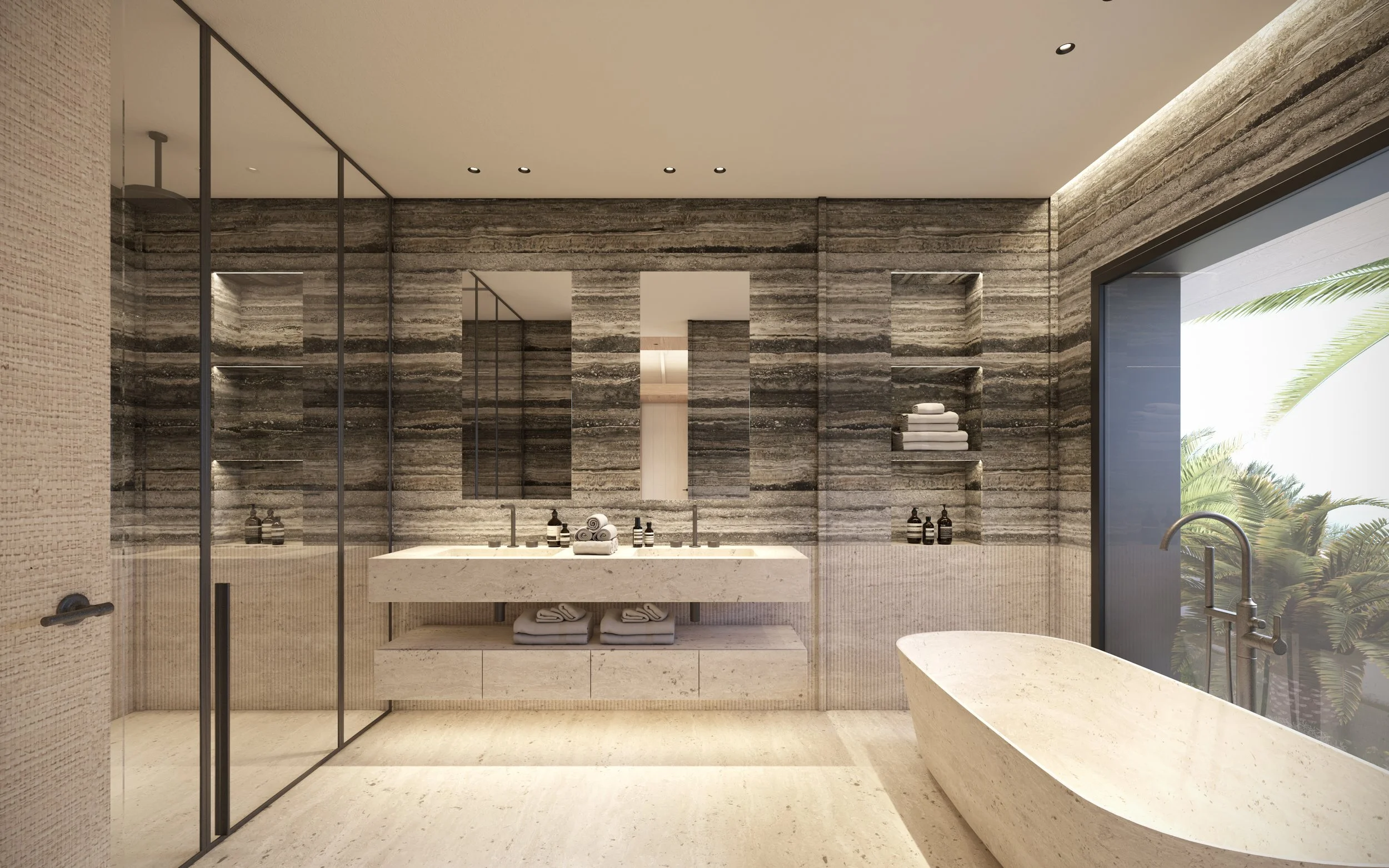 Une salle de bain moderne avec une baignoire en pierre beige, un lavabo double en pierre, des étagères encastrées avec des serviettes et des produits de soin, et une grande fenêtre avec vue sur des palmiers.