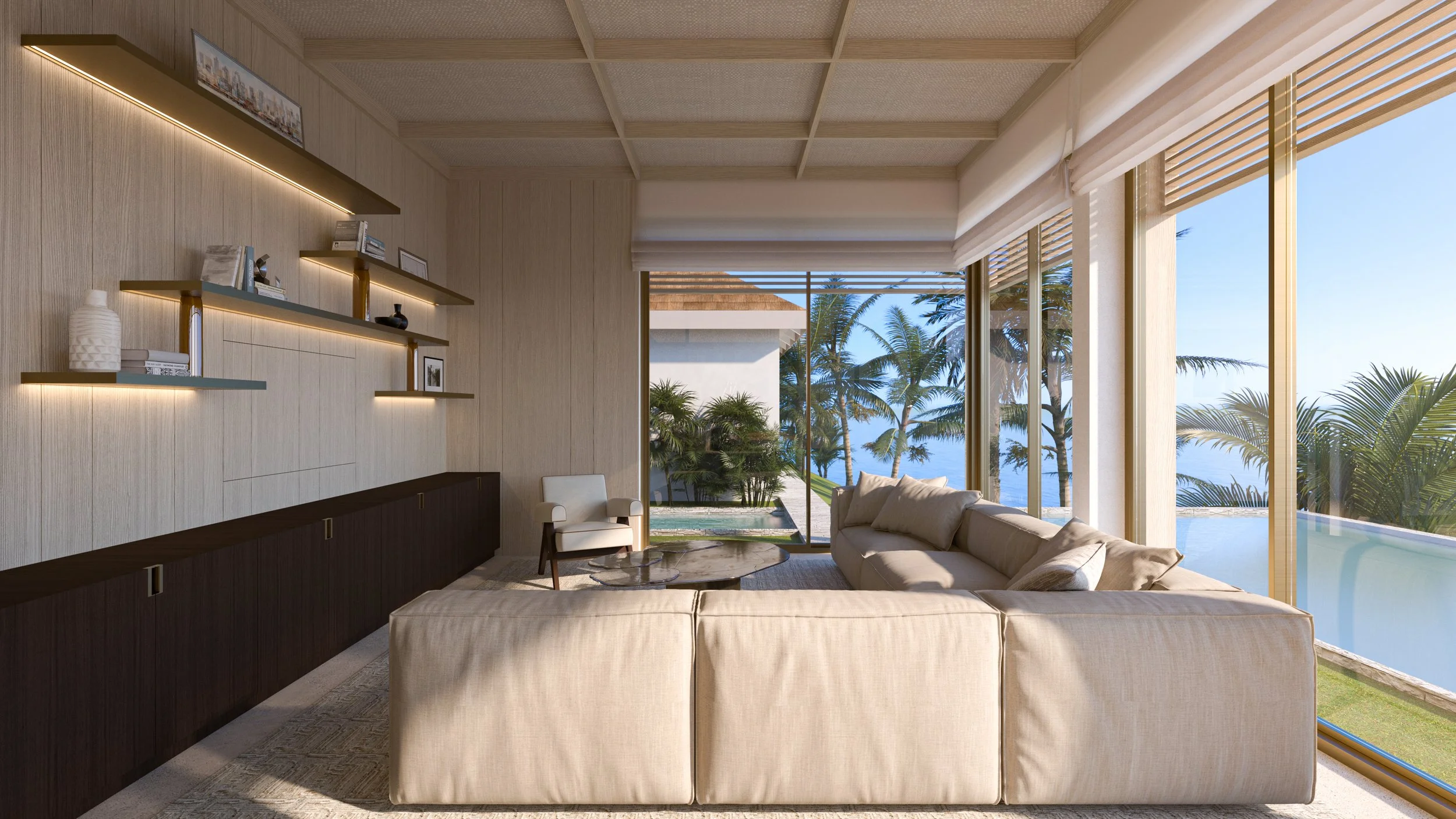 Salon moderne avec vue sur une plage, comprenant un canapé beige, une table basse en bois, des étagères décoratives avec des livres et des objets, et de grandes fenêtres laissant entrer la lumière naturelle.