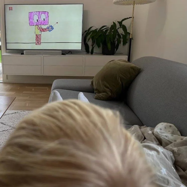 Nogle dage er det her helt rigtigt.

Et barn p&aring; sk&oslash;det.
Tegnefilm i fjernsynet.
En krop, der pr&oslash;ver at blive rask.

Det ligner m&aring;ske ikke det ideelle.

Men n&aring;r jeg er syg, falder ambitionerne.
Ikke fordi jeg er ligegla