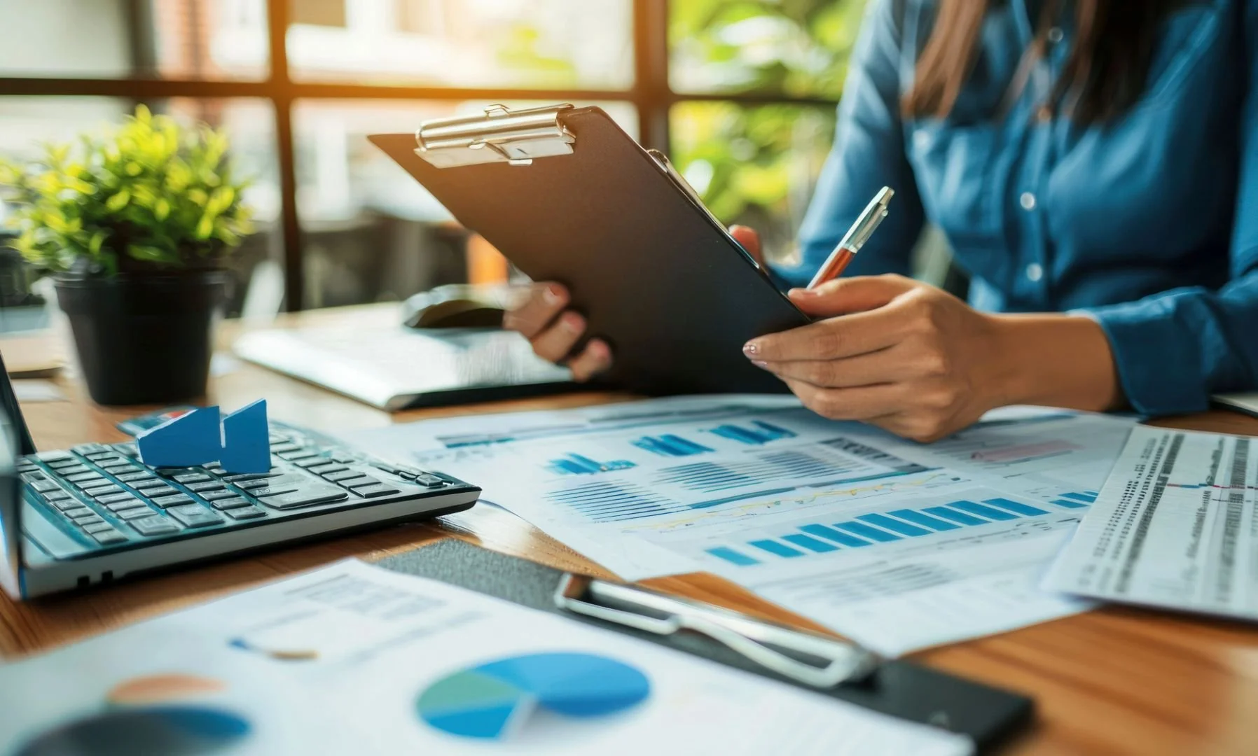 Service provider analyzing financial reports and charts on a tablet device.