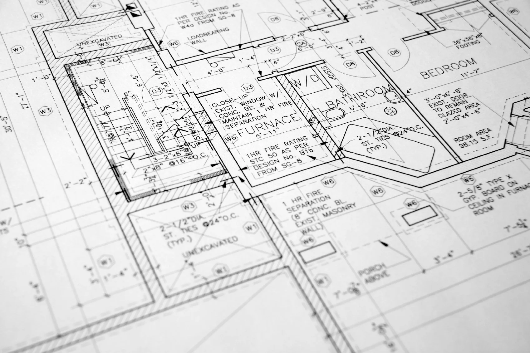 Detailed architectural blueprint of a house floor plan, including rooms such as bedroom and bathroom, with measurements and construction details.