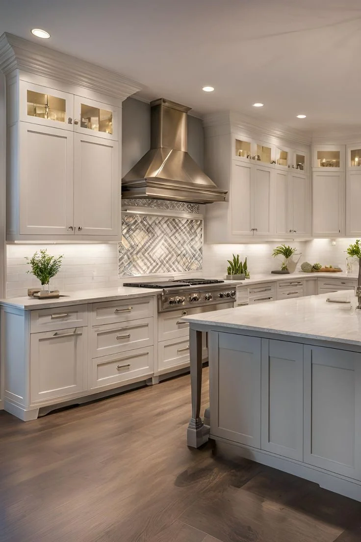 Modern kitchen with white cabinets, a large island, stainless steel range hood, and decorative tile backsplash.