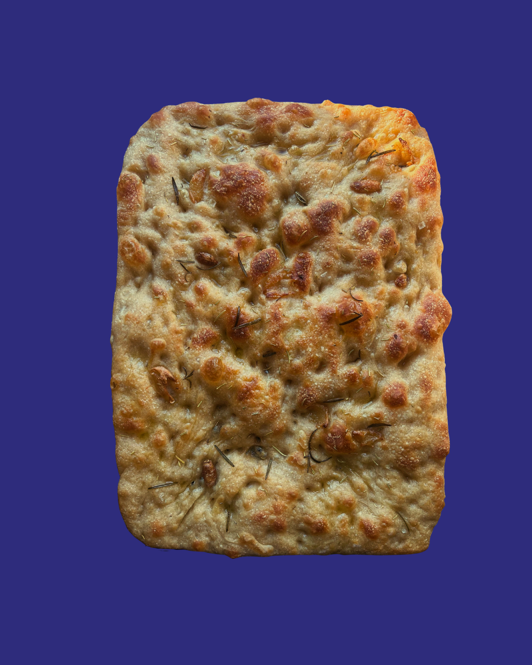 Rectangular flatbread topped with herbs and cheese, with a golden-brown crust and slight bubbling.