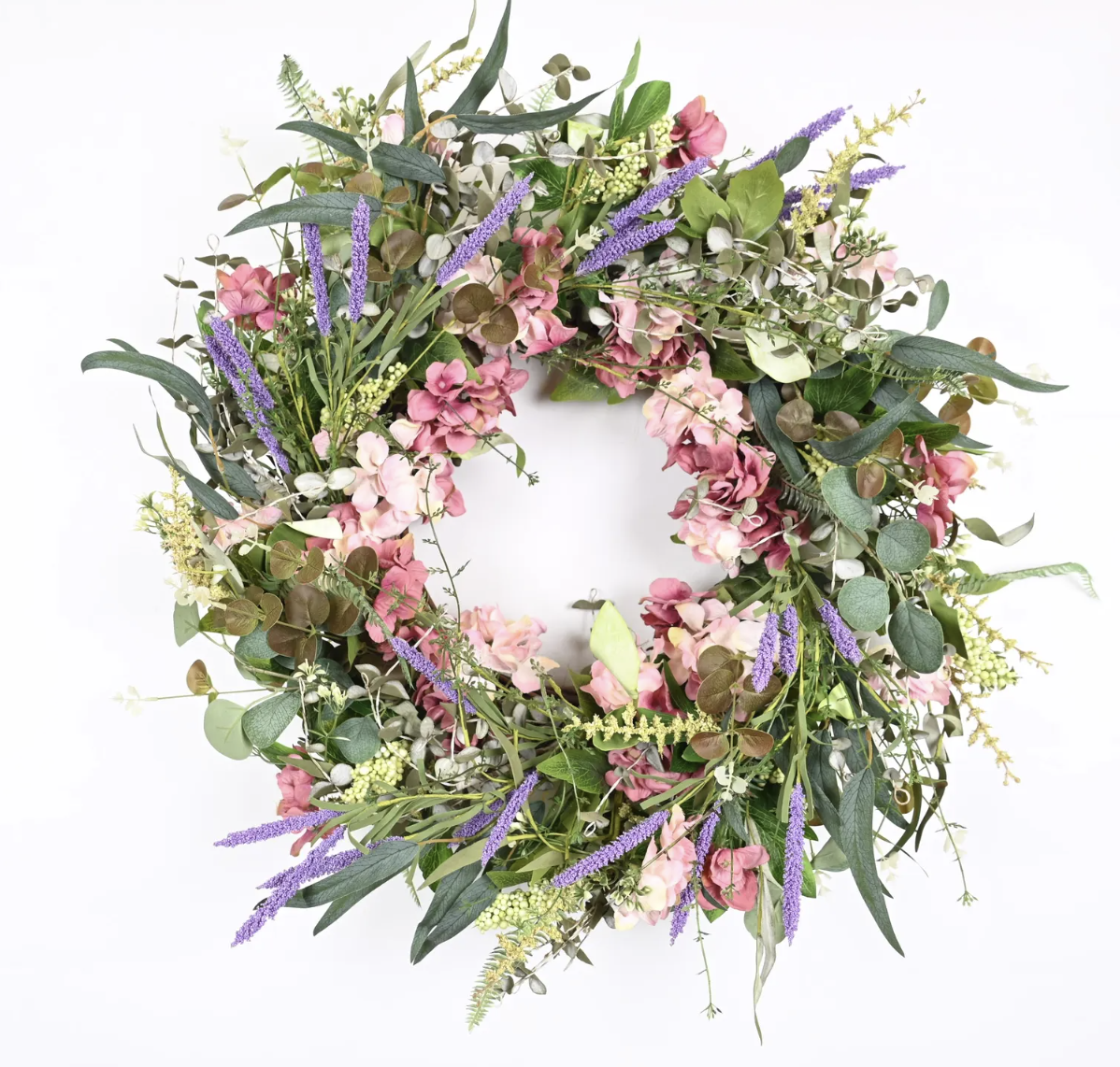 A floral wreath made of pink, purple, and green flowers and foliage against a white background.