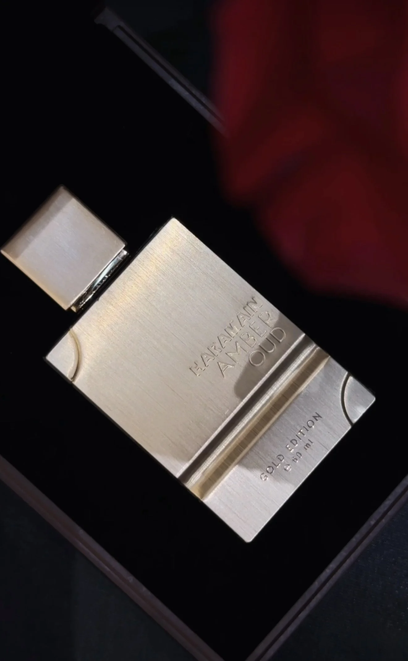 A perfume bottle labeled 'HARRAZANE AMBER OUD GOLD EDITION 3.4 fl oz (100 ml)' in a black box.