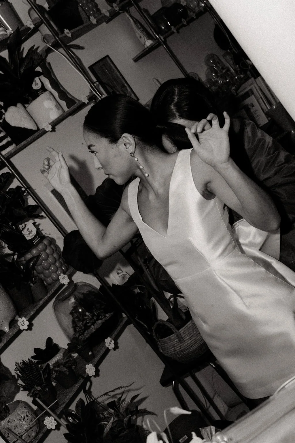 Scène backstage en noir et blanc, mariée dans un instant libre et expressif.