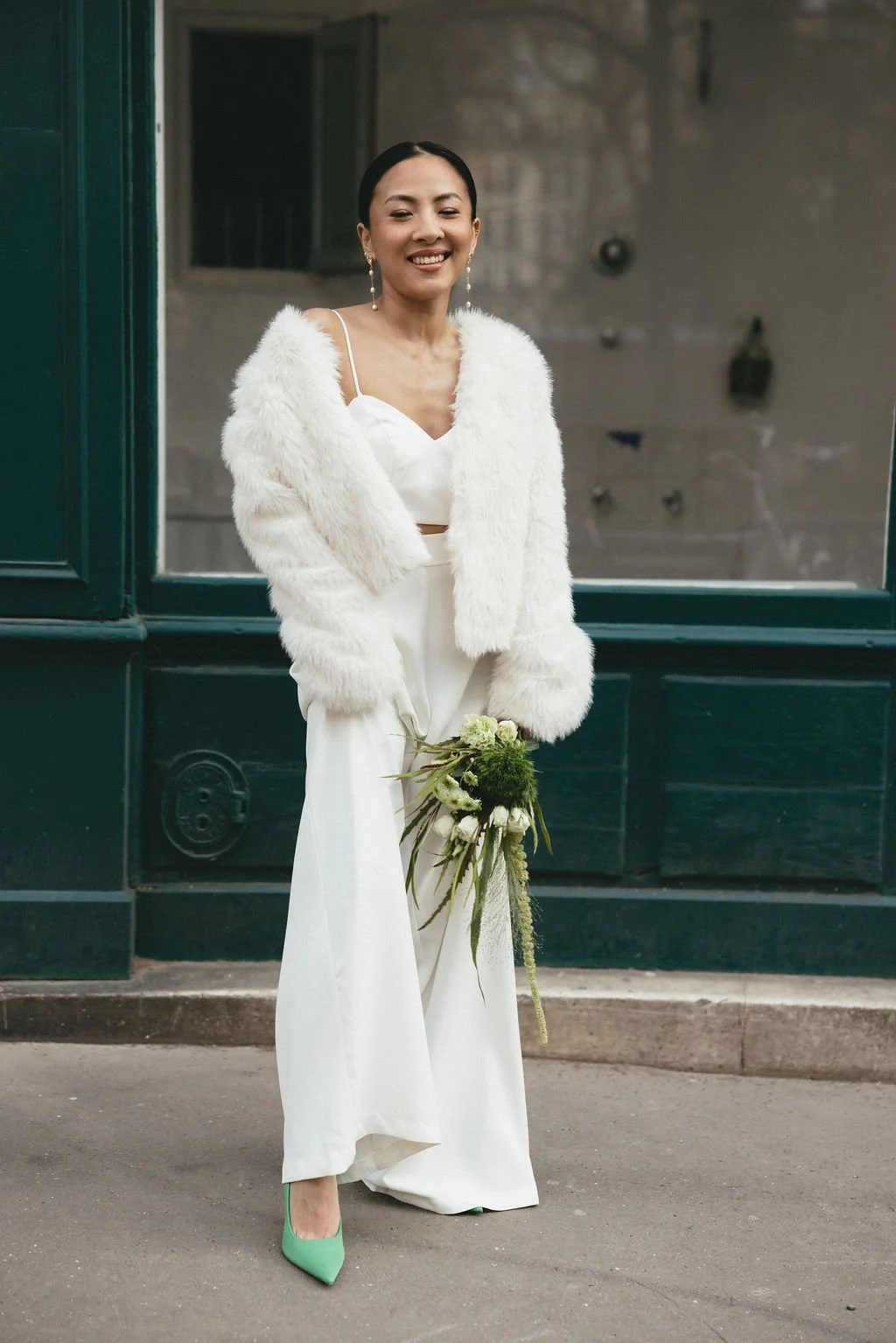 Mariée tenant son bouquet, capturant un moment de joie et de spontanéité lors d’un mariage urbain.