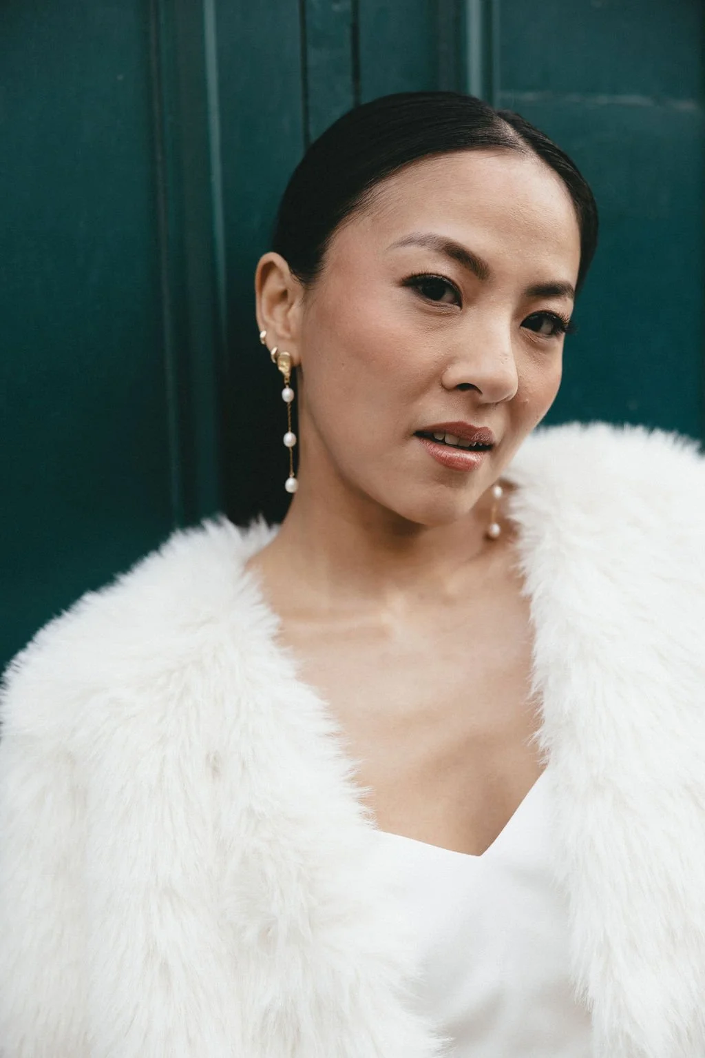 Portrait de mariée contemporaine en tenue blanche, mettant en valeur une élégance sobre et affirmée.