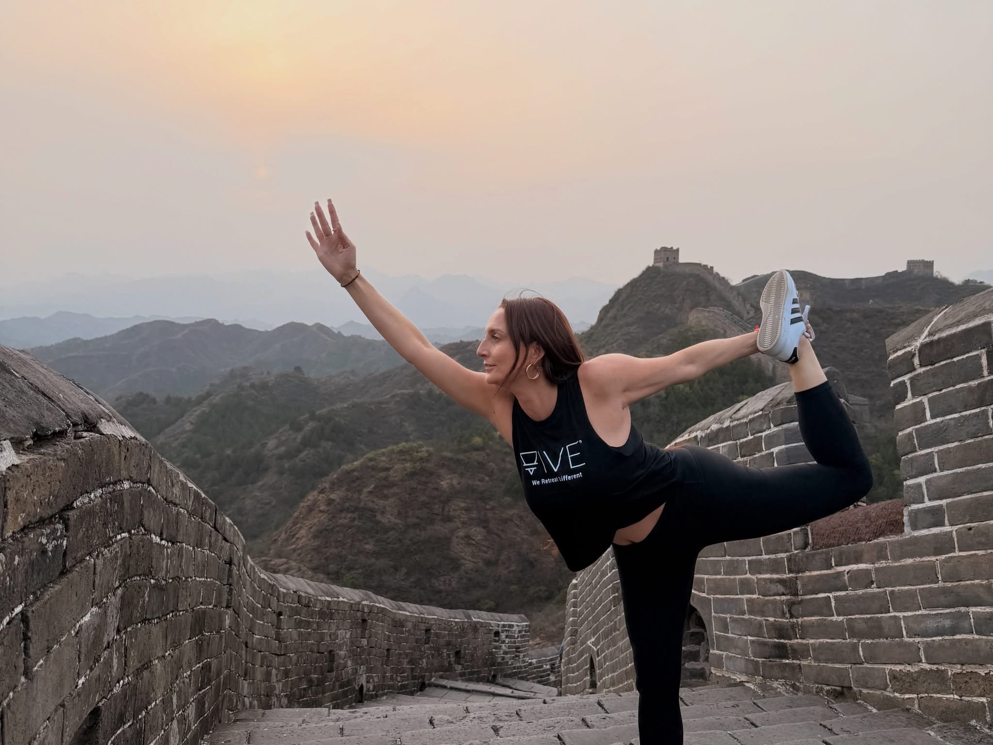 Michelle Ruiz, yoga instructor, doing yoga pose at the Great Wall of China