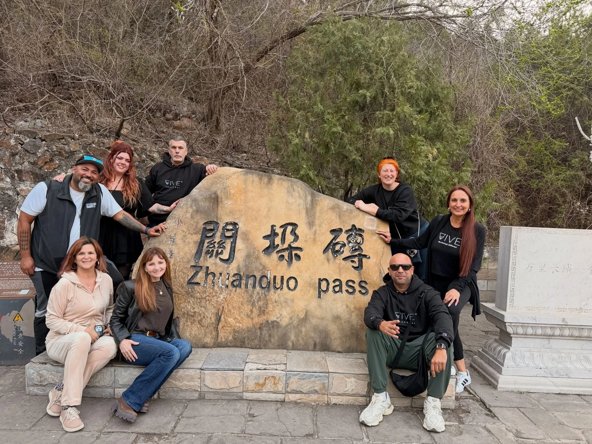 Small group of luxury travelers at the Great Wall of China Zhuanoup Pass