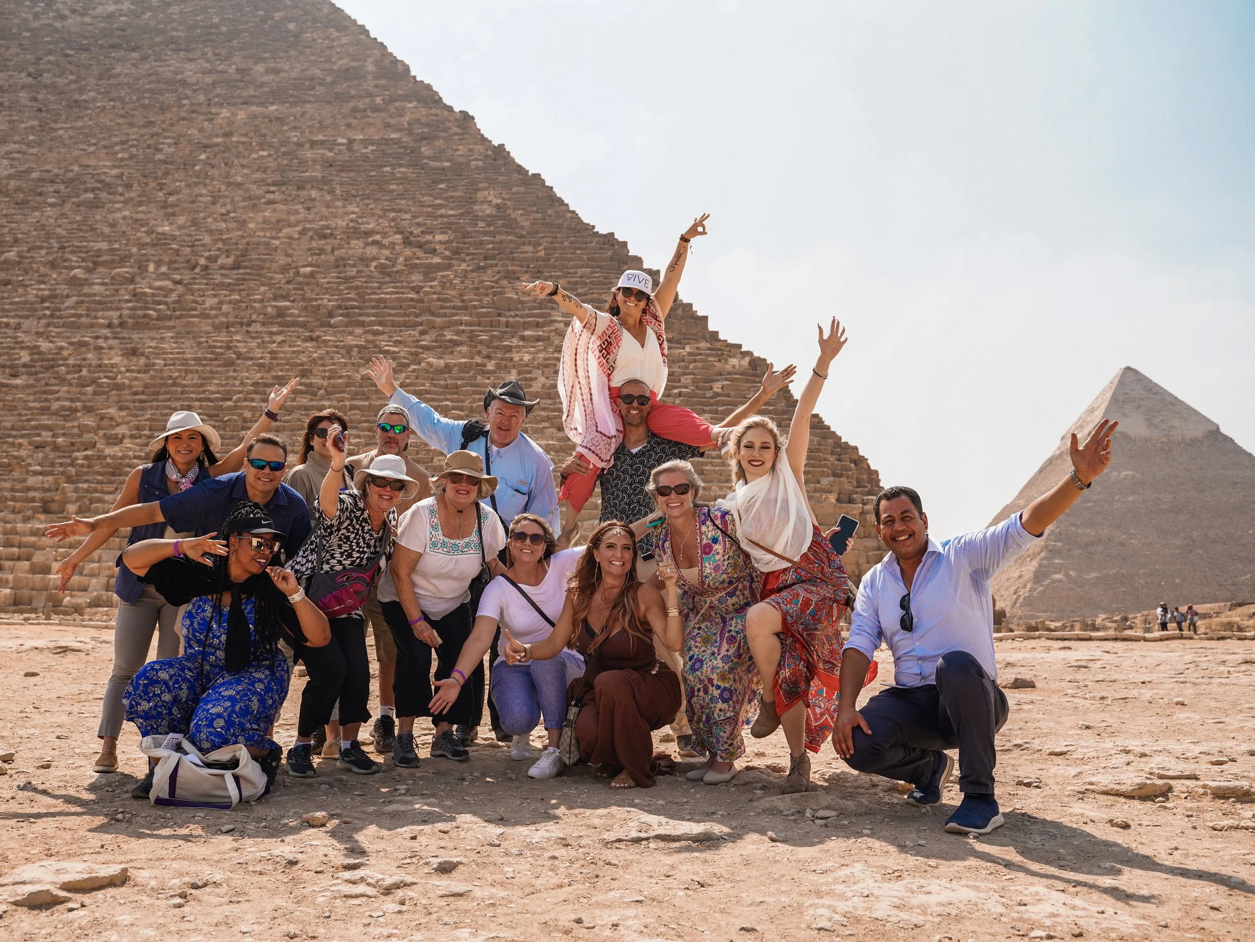 Travelers visiting the pyramids of Giza at sunrise in Egypt