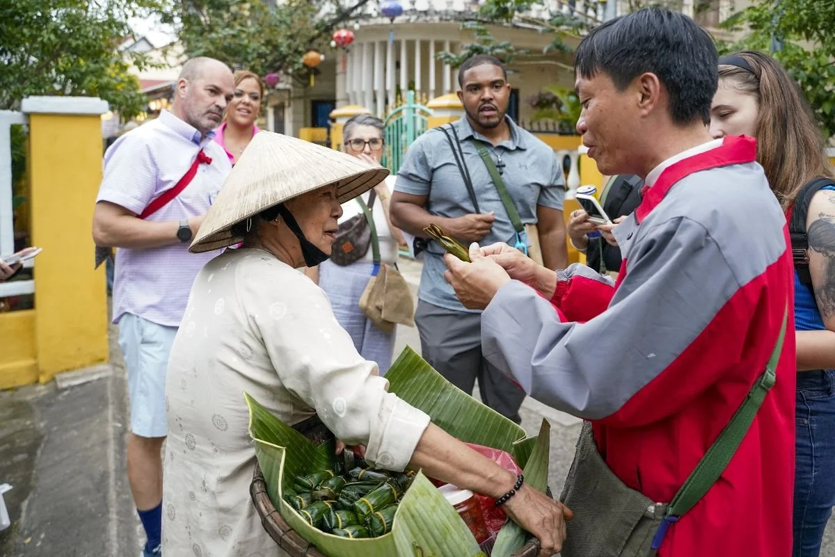VIVE Society group tours to Vietnam. Travelers connect with the local people on the streets of Hoi An