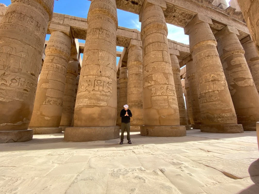 Solo male traveler in Karnak Temple with no crowds in egypt