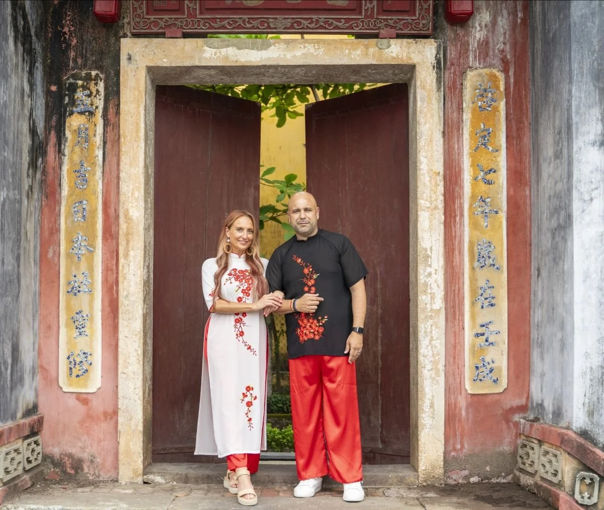 Michelle Ruiz & Nelson Ruiz, Founders of VIVE Society Travel trying on Ao Dai clothing in Vietnam