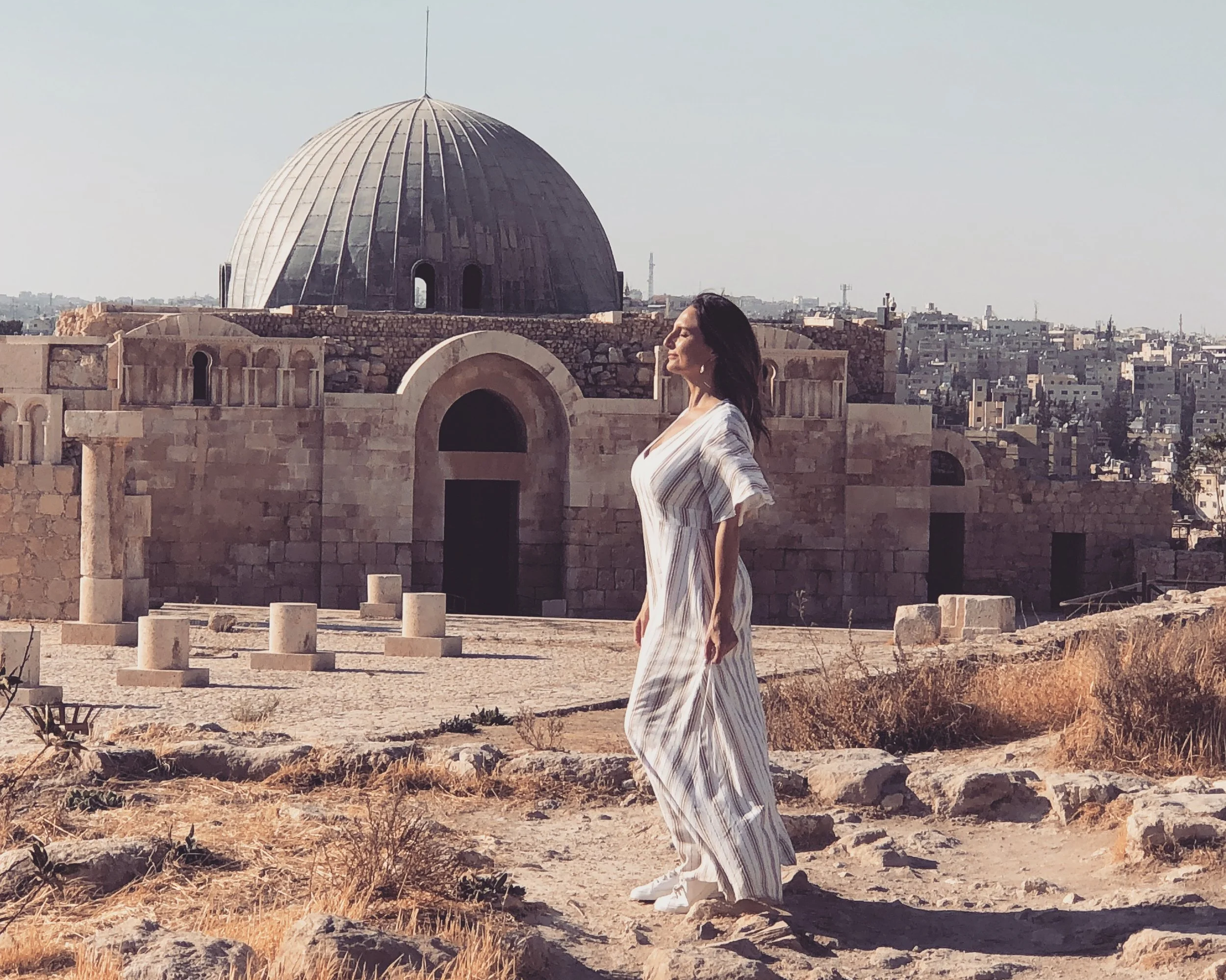 Michelle Ruiz, woman tourist, standing at Umayyad Palace Amman, Jordan