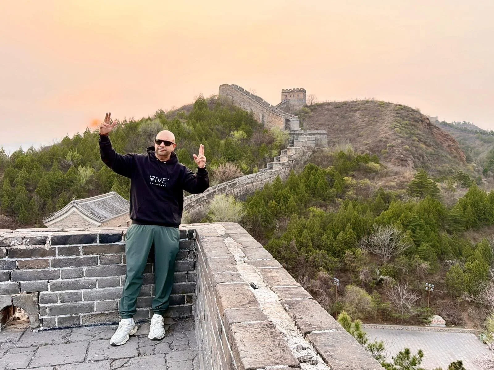 Sunrise hikes at the Great Wall of China. male tourist made it to the top.