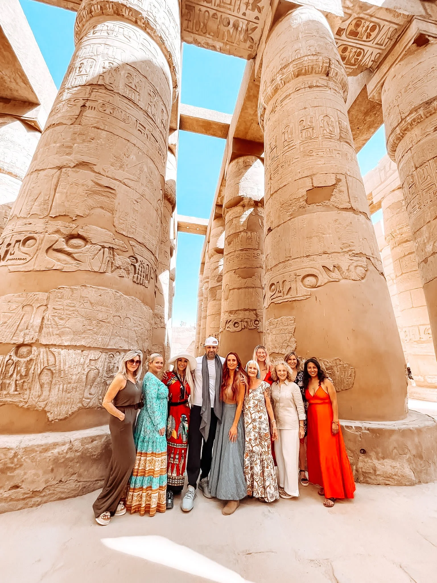 Small group, all womens tour to Egypt. 10 woman standing in Karnak Temple.