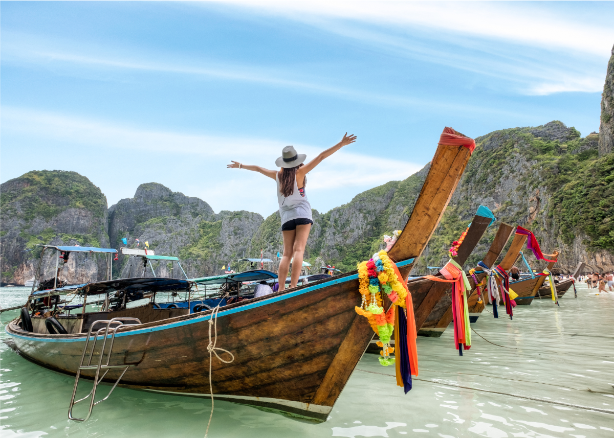 Woman standing on longtail boat in Thailand