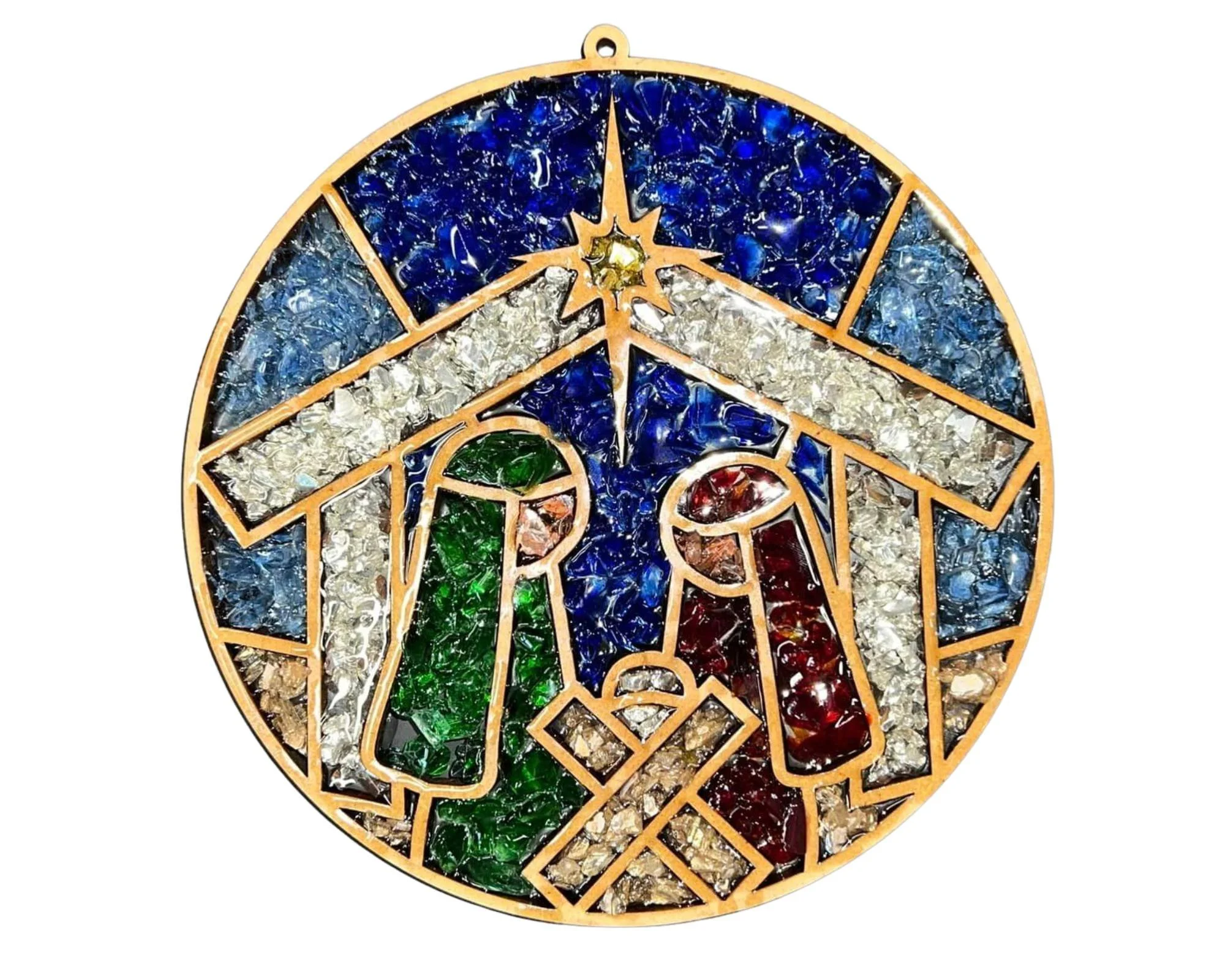Stained glass art depicting the nativity scene with Mary and Joseph surrounding baby Jesus, set against a starry sky with bright colors including blue, green, red, and white.