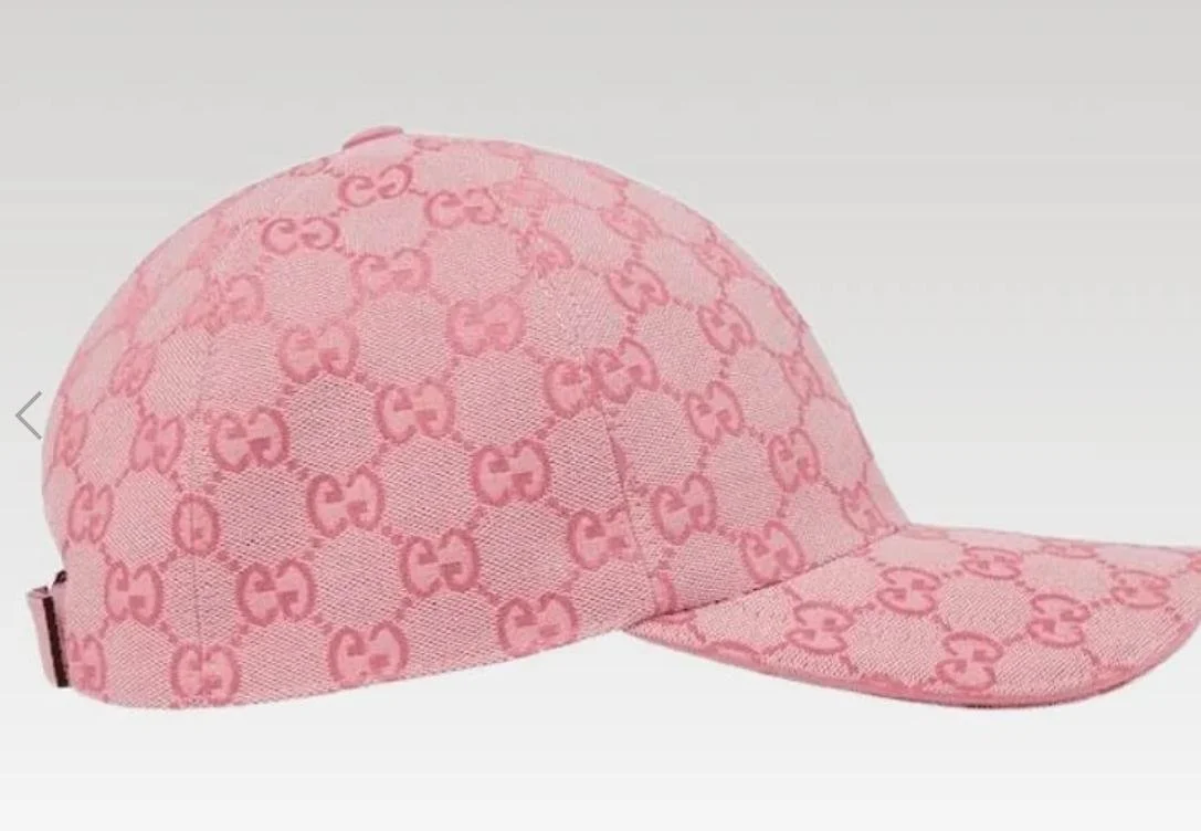 Pink baseball cap with darker pink GG pattern.