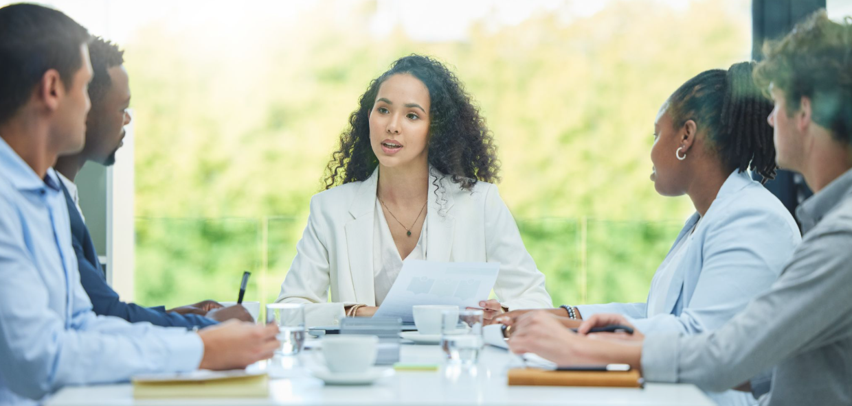 Participants and mediator collaborating during a dispute resolution meeting in an office