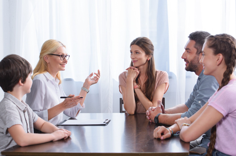Family mediation session with a mediator helping participants communicate and work toward an agreement
