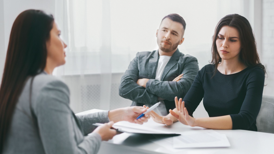 Upset couple meeting with a female divorce mediator to discuss settlement and parenting arrangements
