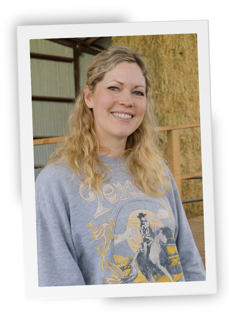 Joan, equine-assisted therapist at HorseSpeak, smiling inside the ranch barn
