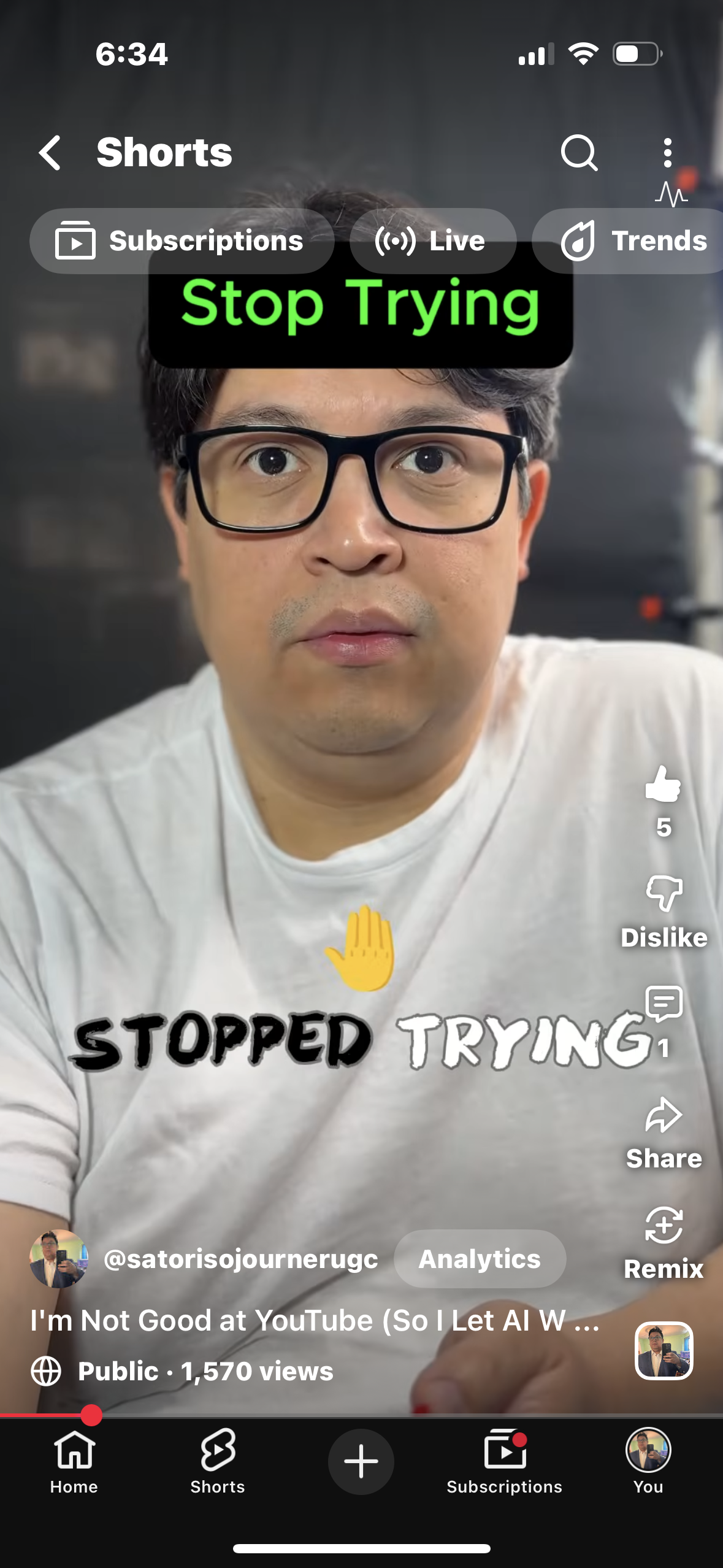 A man with glasses and a white shirt looking directly at the camera in a selfie-style video. Text overlays include 'Stop Trying' in green and 'Stopped Trying' in black and white, with a yellow hand emoji. The video is from a YouTube Shorts page.