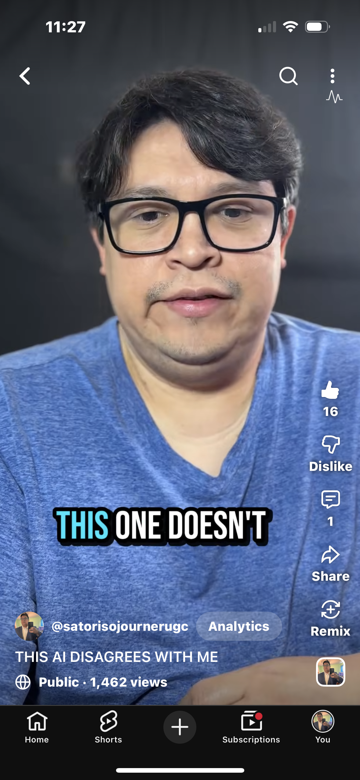 A man with dark hair, glasses, wearing a blue shirt, looking at the camera. Text overlay says, 'THIS ONE DOESN'T'.