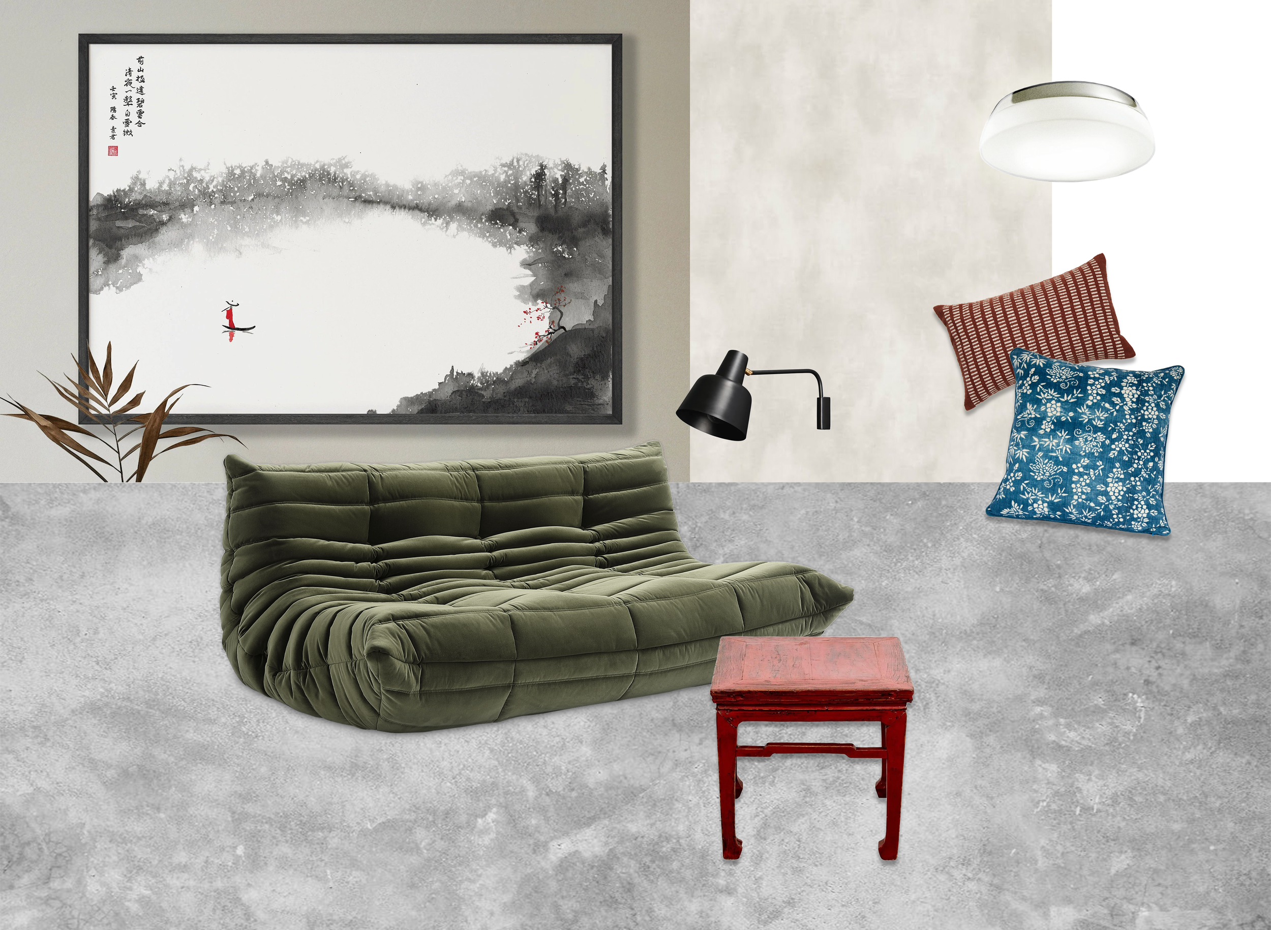 Living room corner with a large framed black and white watercolor landscape painting on the wall, olive green cushioned sofa, red small wooden table, black wall-mounted lamp, white ceiling light, two throw pillows (one red with white striped pattern, one blue with white floral pattern), and a potted plant with brown leaves.