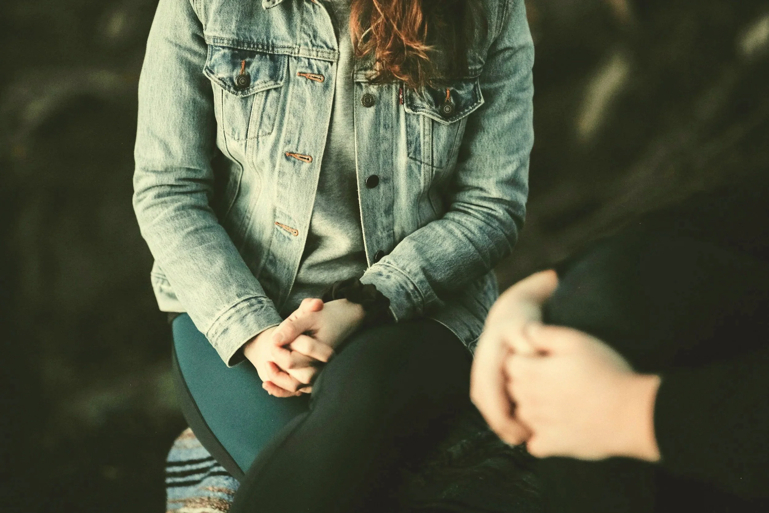 person sitting in therapy session