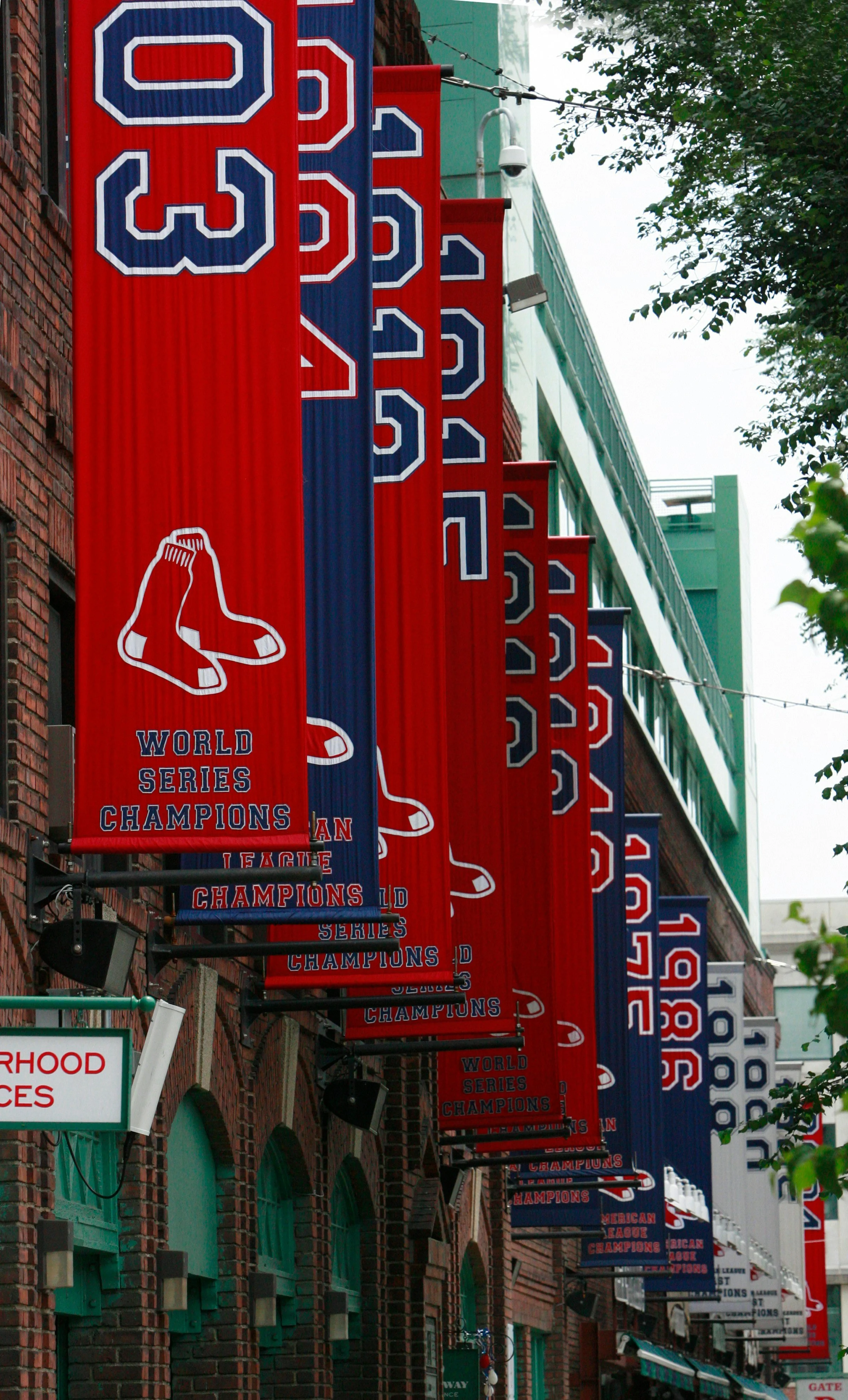 Red and blue banners hanging on a brick building celebrating Boston Red Sox 2018 World Series Championship.