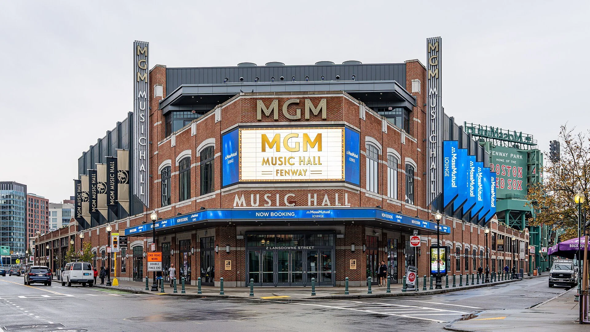 Exterior of MGM Music Hall at Fenway Park with large digital sign displaying venue name, brick facade, and surrounding street景观.