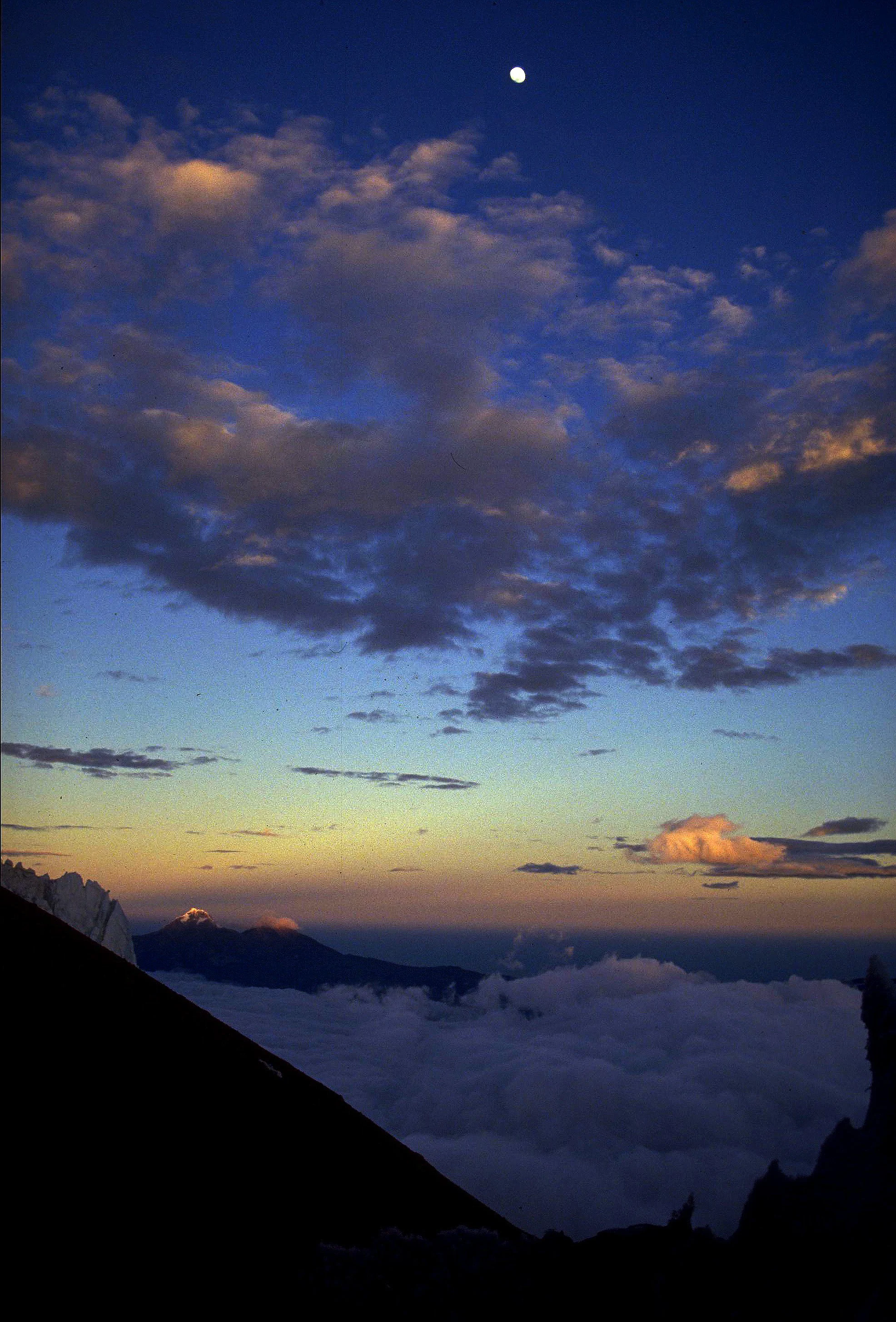 Daybreak on Cotopaxi, Illinizas to the West. Third quarter moon.