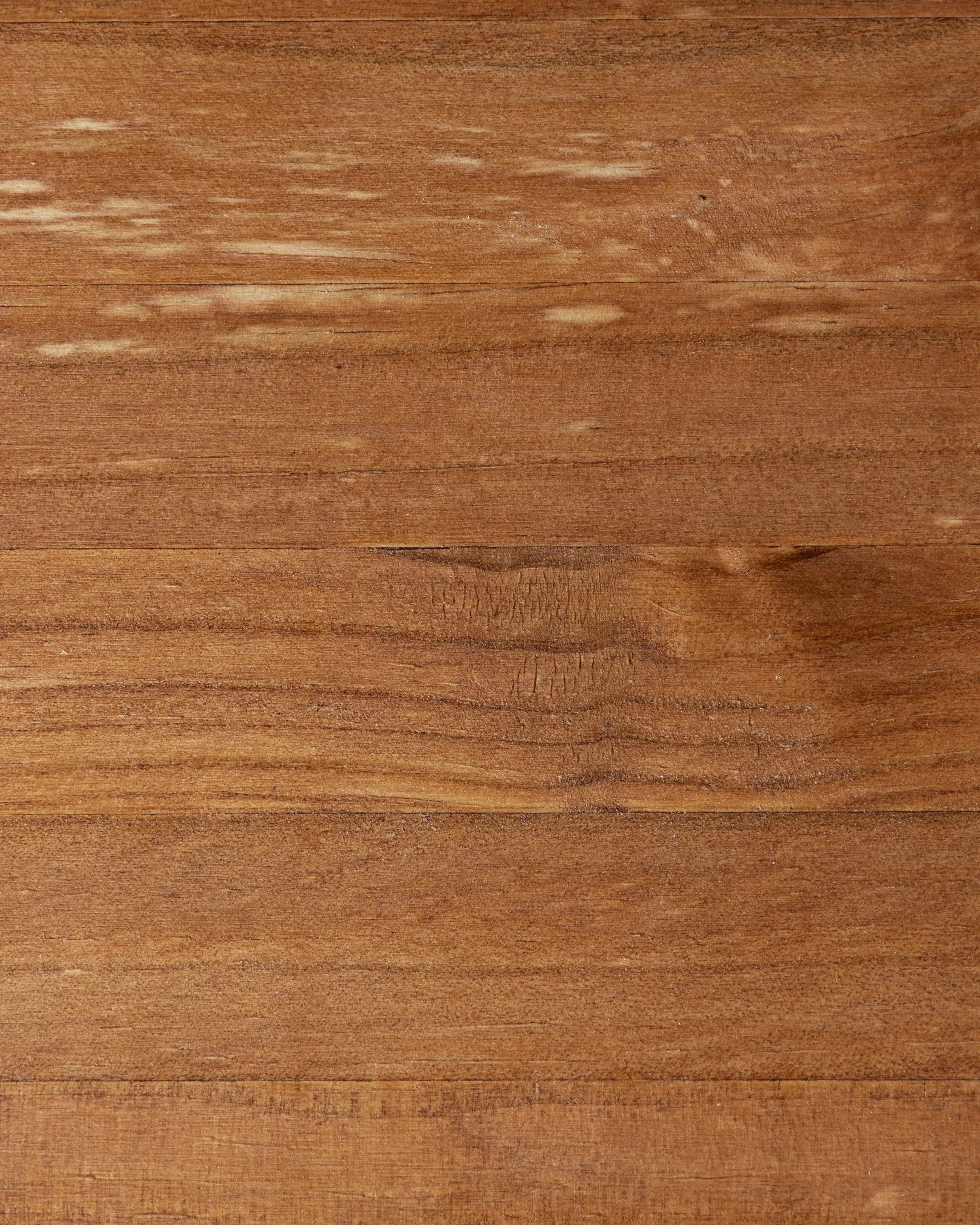 Close-up of a wooden surface with visible wood grain and texture.