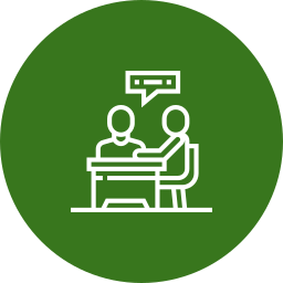 Two people sitting at a table having a conversation, with a speech bubble above them.